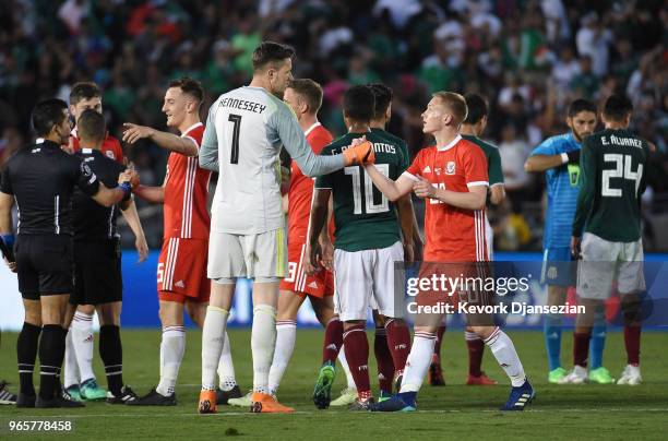 Goalkeeper Wayne Hennessey of Wales is congratulated by teammate Matthew Smith after their friendly international soccer match at the Rose Bowl on...