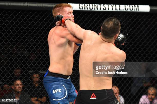 Sam Alvey punches Gian Villante in their light heavyweight fight during the UFC Fight Night event at the Adirondack Bank Center on June 1, 2018 in...