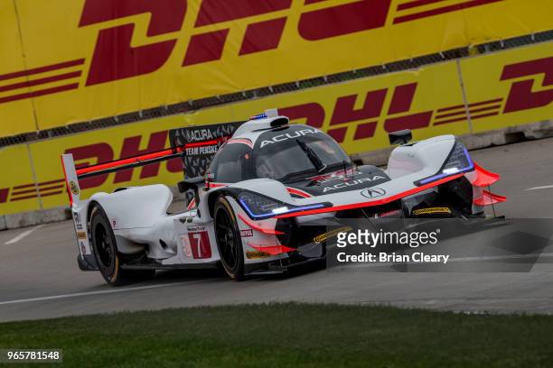 The Acura DPi of Helio Castroneves of Brazil and Ricky Taylor races on the track during practice for the IMSA WeatherTech Series sportscar race at...
