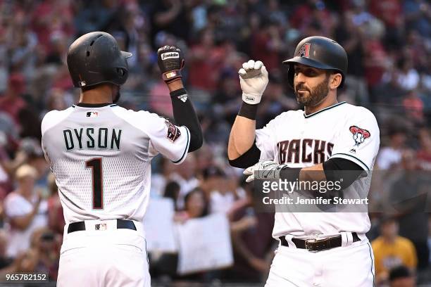 Daniel Descalso of the Arizona Diamondbacks celebrates a two-run home run with Jarrod Dyson in the second inning of the MLB game against the Miami...