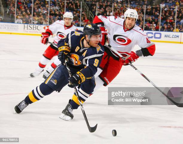 Derek Roy of the Buffalo Sabres skates around Andrew Alberts of the Carolina Hurricanes on February 5, 2010 at HSBC Arena in Buffalo, New York. The...