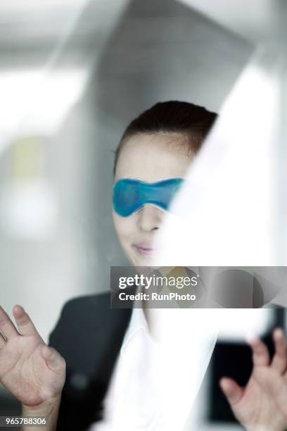 businesswoman with sleeping mask - computer wearing eye mask stock pictures, royalty-free photos & images