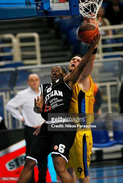 Strahinja Milosevic, #8 of Partizan Belgrade competes with Jared Homan, #9 of Maroussi BC during the Euroleague Basketball 2009-2010 Last 16 Game 3...