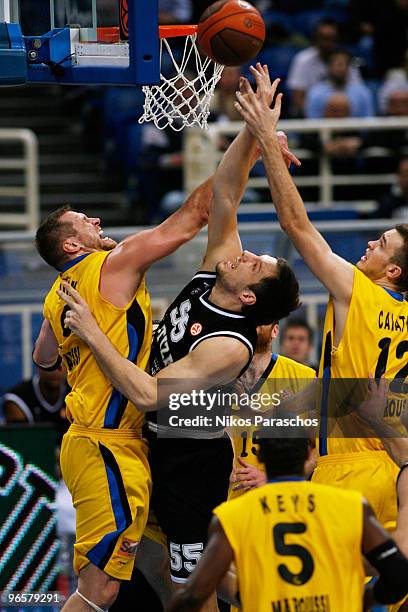 Stevan Milosevic, #55 of Partizan Belgrade competes with Jared Homan, #9 of Maroussi BC during the Euroleague Basketball 2009-2010 Last 16 Game 3...