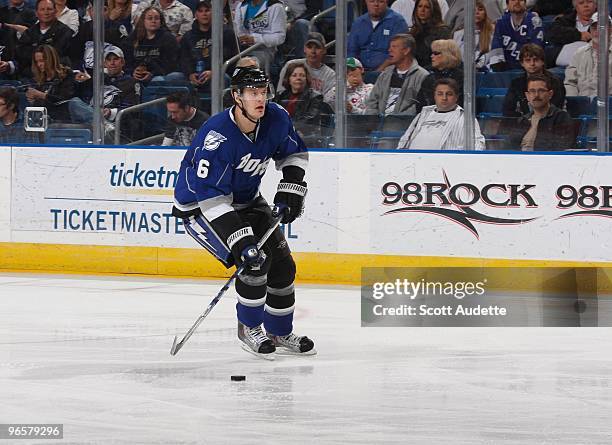 Kurtis Foster of the Tampa Bay Lightning passes the puck against the Calgary Flames at the St. Pete Times Forum on February 6, 2010 in Tampa, Florida.