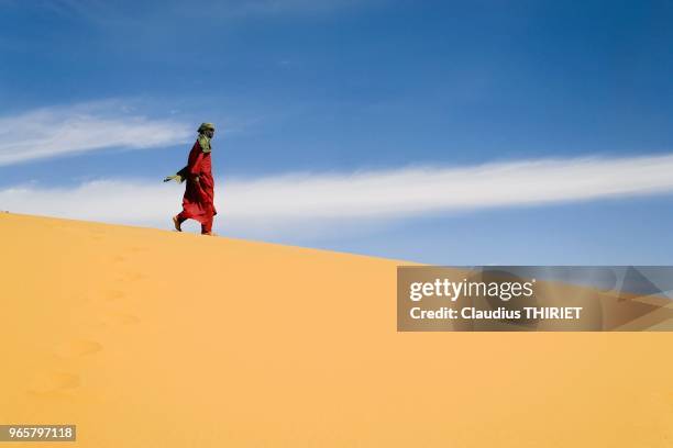 Sahara. Touareg marchant sur une dune de sable dans desert.