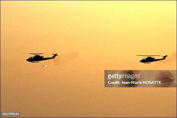 Air-ground missile shoot by Cobra helicopters. These helicopters are similar to those used in targeted assassinations. The second helicopter covers...
