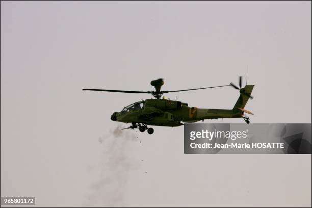 Cobra attack helicopter of the Israeli army with front machineguns in continuous fire.