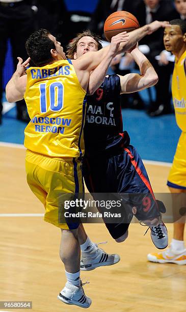 Carlos Cabezas, #10 of BC Khimki Moscow Region competes with Marcelinho Huertas, #9 of Caja Laboral during the Euroleague Basketball 2009-2010 Last...