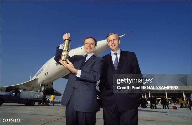 Jean-Claude Killy and Michel Barnier in front of Concorde jet.