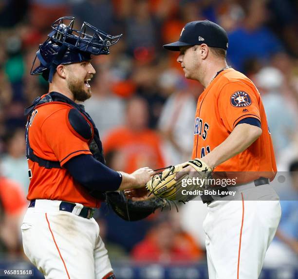 Max Stassi of the Houston Astros shakes hands with Brad Peacock after the final out against the Boston Red Sox at Minute Maid Park on June 1, 2018 in...