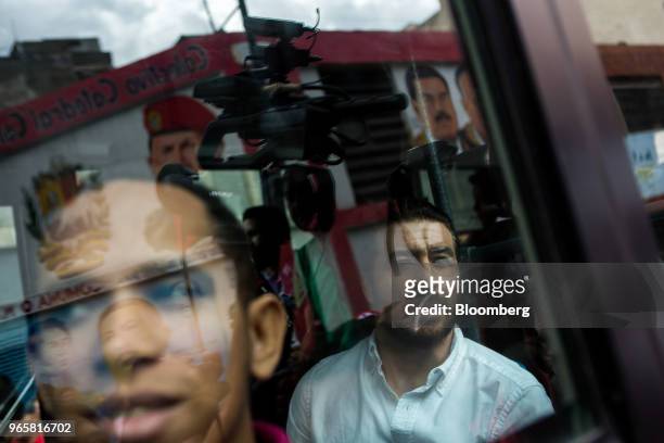 Daniel Ceballos, former San Cristobal mayor, right, sits in a vehicle while being transported from a chancellery to the Bolivarian Intelligence...