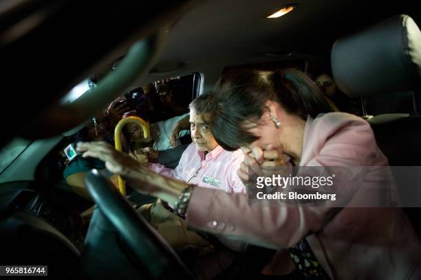 Retired general Angel Vivas, left, sits in a vehicle with his wife outside the Bolivarian Intelligence Service prison in Caracas, Venezuela, on...
