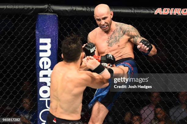 Ben Saunders kicks Jake Ellenberger in their welterweight fight during the UFC Fight Night event at the Adirondack Bank Center on June 1, 2018 in...