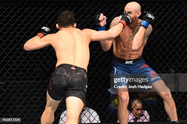 Jake Ellenberger punches Ben Saunders in their welterweight fight during the UFC Fight Night event at the Adirondack Bank Center on June 1, 2018 in...