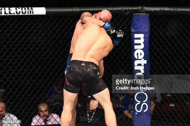 Ben Saunders lands a knee to the body of Jake Ellenberger in their welterweight fight during the UFC Fight Night event at the Adirondack Bank Center...