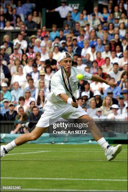 Wimbledon, uk june 28, 2001 lleyton hewitt, australia hitting a volley during his match with big serving american taylor dent. Photo by art seitz.