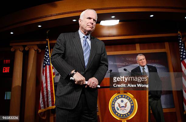 Sen. John McCain and Sen. Jon Kyl listen during a news conference on Capitol Hill February 11, 2010 in Washington, DC. The senators held a news...