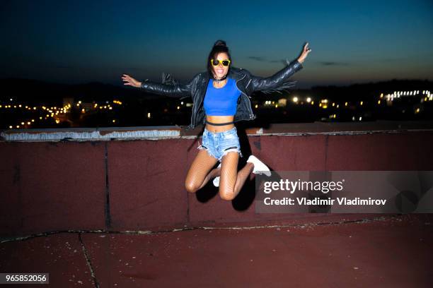 cheerful young woman jumping - flash photography stock pictures, royalty-free photos & images