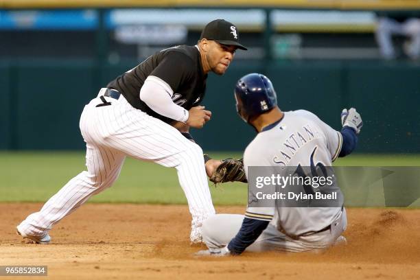 Domingo Santana of the Milwaukee Brewers slides into second base for a double past Yoan Moncada of the Chicago White Sox in the third inning at...