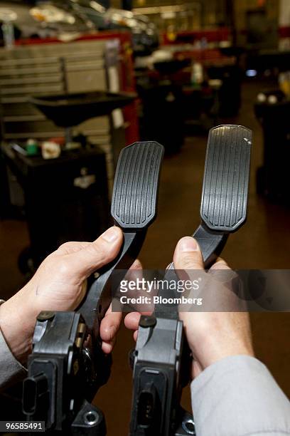 Technician displays a modified accelerator pedal, left, and the original recalled pedal at the Caldwell Toyota dealership in West Caldwell, New...