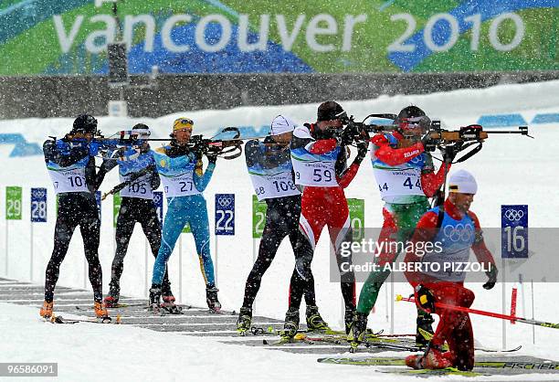 Athletes shoot under heavy snow fall during a training session for the Biathlon men's event in Whistler Olympic park, in preparation for the...