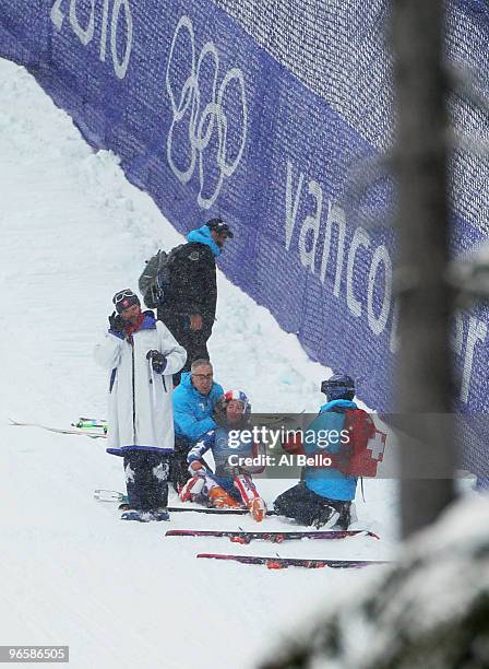 Stacey Cook of United States receives medical attention shortly before being air-lifted off the slope by helicopter during the Ladies Downhill...