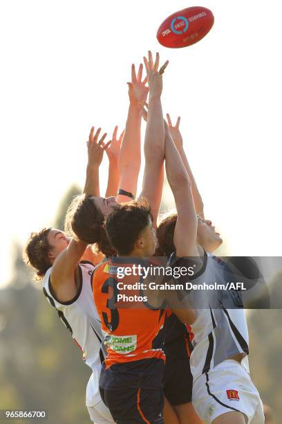 Joshua Mawson of the Rebels and Ismail Moussa of the Calder Cannons compete in the air during the round eight TAC Cup match between the Calder...