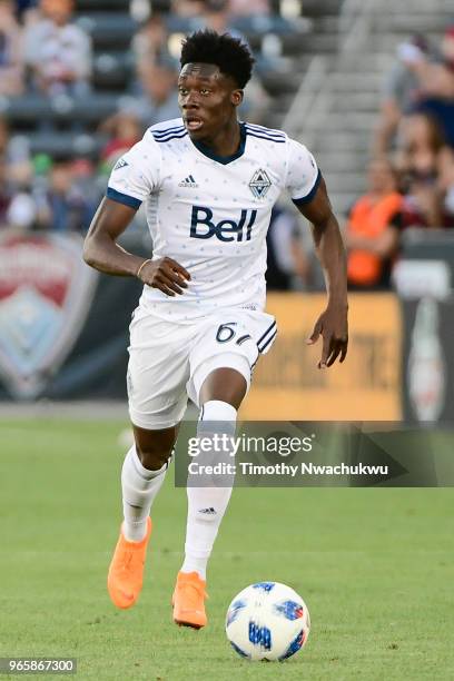 Alphonso Davies of Vancouver Whitecaps dribbles upfield against the Colorado Rapids at Dick's Sporting Goods Park on June 1, 2018 in Commerce City,...