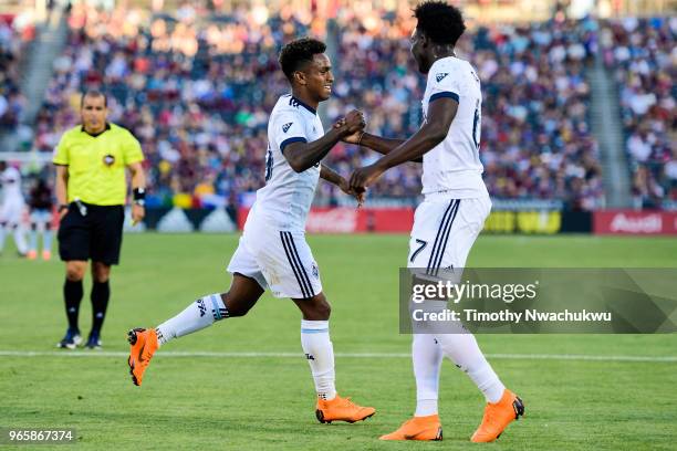 Yordi Reyna and Alphonso Davies of Vancouver Whitecaps celebrate Reyna's goal against the Colorado Rapids at Dick's Sporting Goods Park on June 1,...