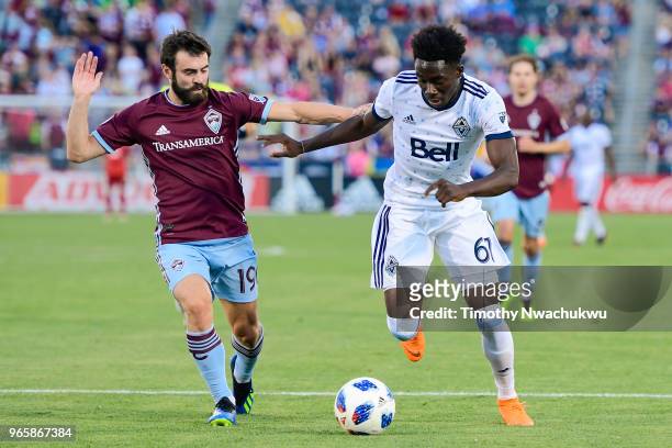 Jack Price of Colorado Rapids chases Alphonso Davies of Vancouver Whitecaps at Dick's Sporting Goods Park on June 1, 2018 in Commerce City, Colorado.