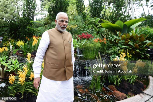 Indian Prime Minister Narendra Modi tours the orchid garden after the orchid naming ceremony at the National Orchid Gardens on June 2, 2018 in...