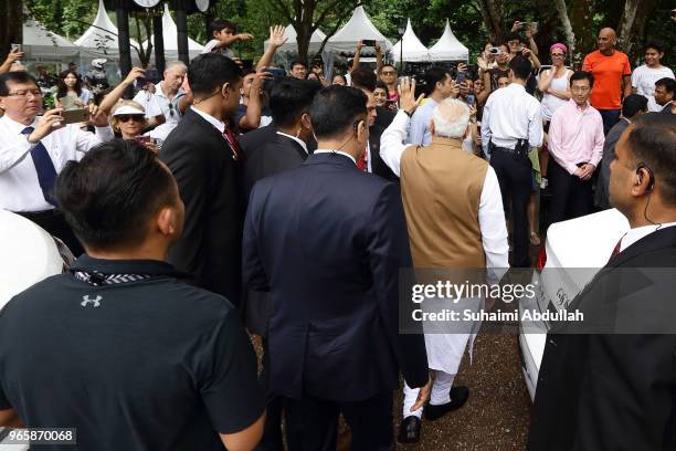 Indian Prime Minister Narendra Modi leaves after attending an orchid naming ceremony at the National Orchid Gardens on June 2, 2018 in Singapore....