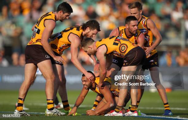 Jarman Impey of the Hawks is congratulated by his teammates after kicking a goal during the round 11 AFL match between the Hawthorn Hawks and the...