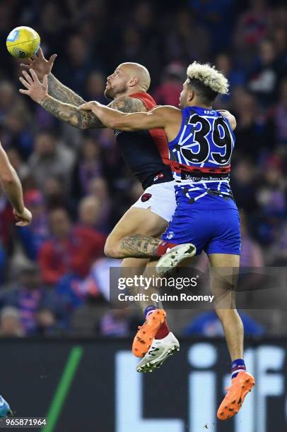 Nathan Jones of the Demons marks infront of Jason Johannisen of the Bulldogs during the round 11 AFL match between the Western Bulldogs and the...