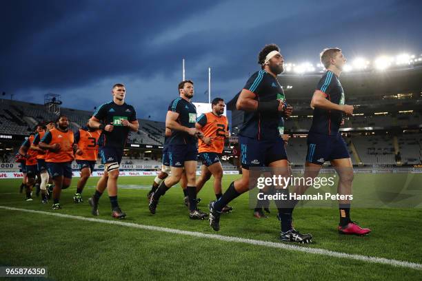 Alex Hodgman and Matt Duffie of the Blues lead the team in ahead of the round 16 Super Rugby match between the Blues and the Rebels at Eden Park on...