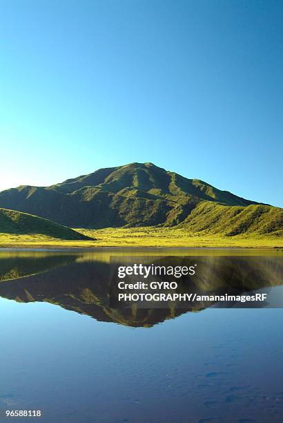 mt. aso reflected in a calm lake, kumamoto prefecture, japan - kumamoto prefecture stock pictures, royalty-free photos & images