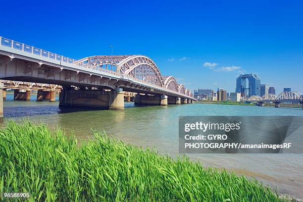 yodo river and skyline of umeda, osaka prefecture, honshu, japan - osaka skyline stock pictures, royalty-free photos & images