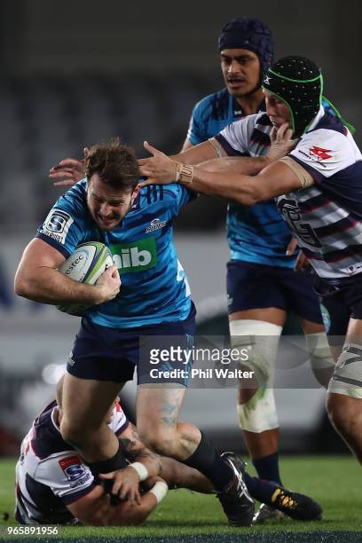 Matt Moulds of the Blues is tackled during the round 16 Super Rugby match between the Blues and the Rebels at Eden Park on June 2, 2018 in Auckland,...