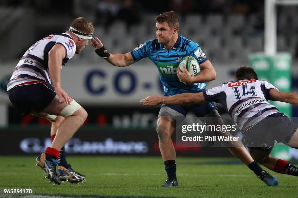 Michael Collins of the Blues makes a break during the round 16 Super Rugby match between the Blues and the Rebels at Eden Park on June 2, 2018 in...