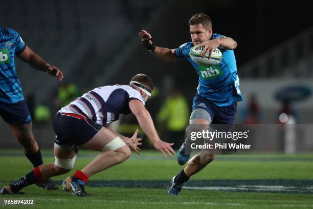 Michael Collins of the Blues makes a break during the round 16 Super Rugby match between the Blues and the Rebels at Eden Park on June 2, 2018 in...