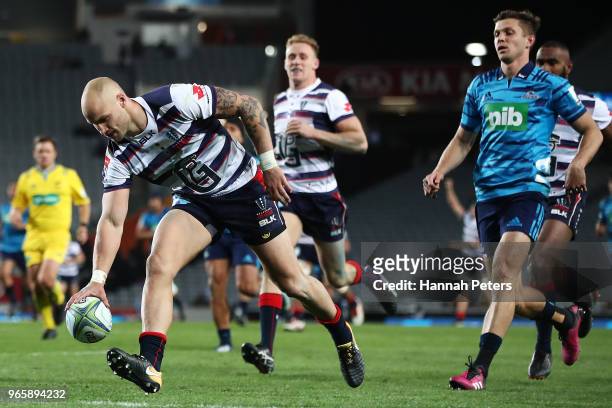 Billy Meakes of the Rebels runs away to score a try during the round 16 Super Rugby match between the Blues and the Rebels at Eden Park on June 2,...