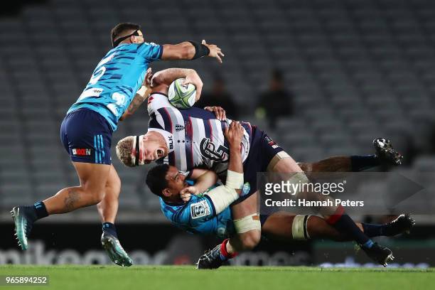 Jerome Kaino of the Blues tackles Matt Philipm of the Rebels during the round 16 Super Rugby match between the Blues and the Rebels at Eden Park on...
