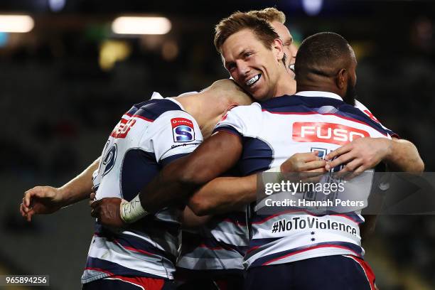 Billy Meakes of the Rebels celebrates with Marika Koroibete of the Rebels after scoring a try during the round 16 Super Rugby match between the Blues...