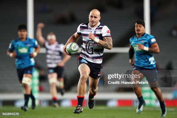 Billy Meakes of the Rebels runs away to score a try during the round 16 Super Rugby match between the Blues and the Rebels at Eden Park on June 2,...