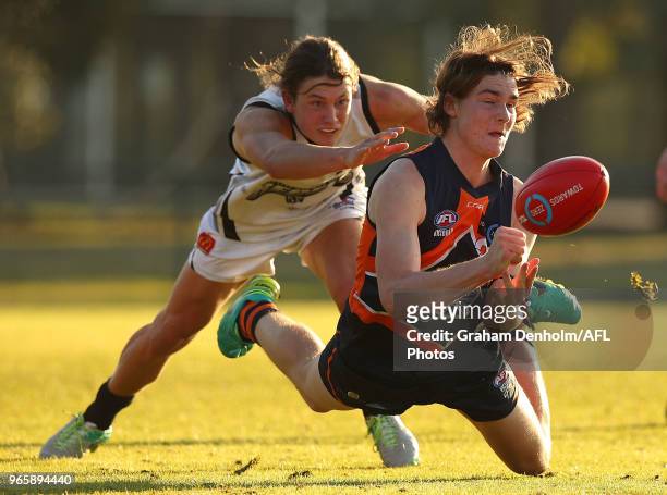 Brodie Newman of the Calder Cannons handballs during the round eight TAC Cup match between the Calder Cannons and Greater Western Victoria Rebels at...