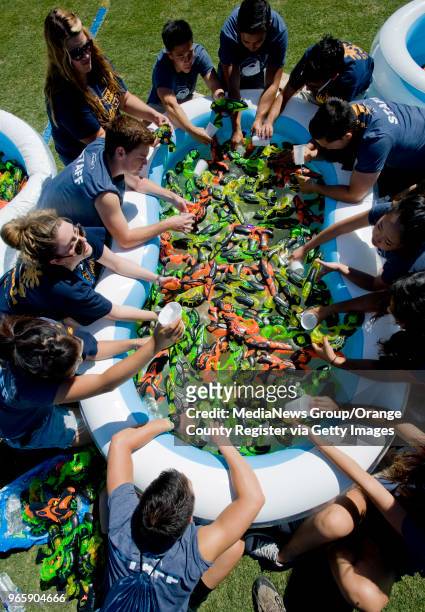 Organizers fill water blasters before the attempt on the Guinness World Record for the World's Largest Water Blaster Fight on campus in Irvine, CA on...