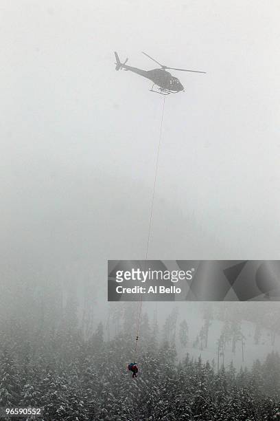 Stacey Cook of United States is air-lifted off the slope by helicopter during the Ladies Downhill training run at Whistler Creekside ahead of the...