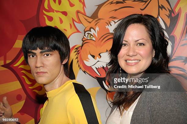 Shannon Lee, daughter of the late martial arts actor Bruce Lee, poses with a new lifelike wax statue of her father at its unveiling at Madame...