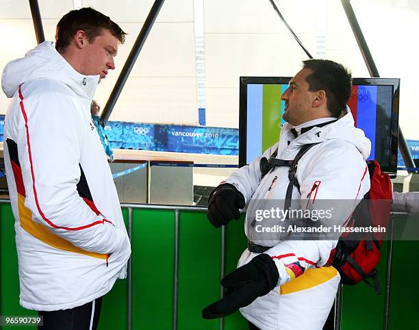 Felix Loch of Germany talks to Georg Hackl former Olympic champion and now a coach in the German team during the Men's Singles Luge training run at...